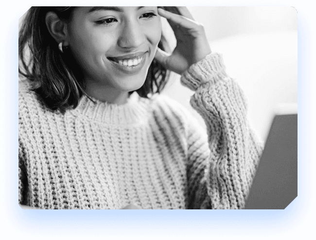 Smiling person using a laptop